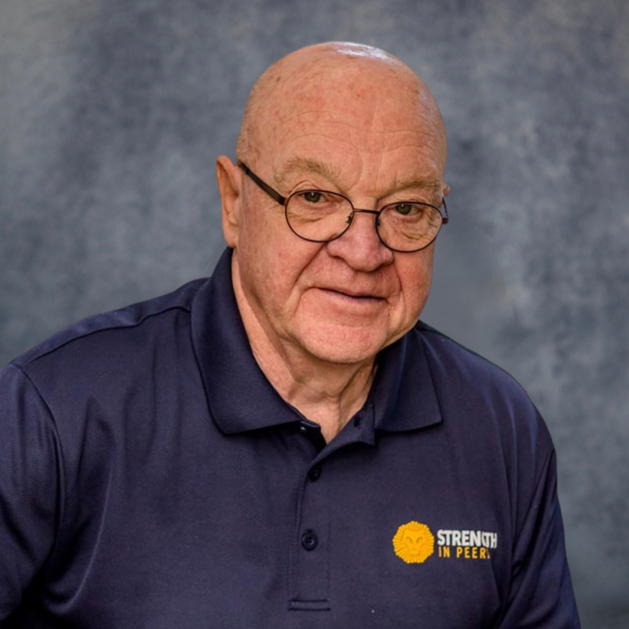 Image of male staff member with blue background